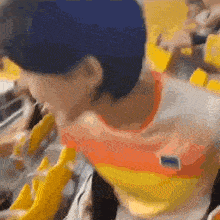 a blurry picture of a person wearing a yellow and orange shirt with a flag on it