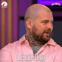 a man with a tattoo on his neck is wearing a pink shirt and says we got this