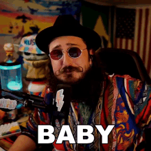 a man wearing a hat and sunglasses says baby