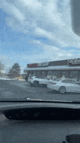 a white car is parked in front of a store that says coney island