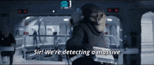 a man in a black suit says sir we 're detecting a massive ..