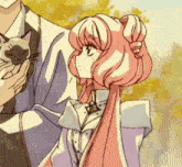 a girl with pink hair holds a cat in her arms