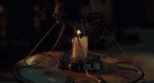 a woman and a boy are lighting a candle together in a dark room .