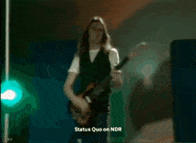 a blurred image with the words status quo on ndr on the bottom