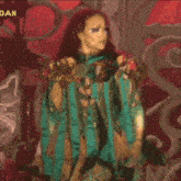 a woman is singing into a microphone and the word dan is on the bottom right