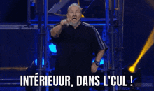a man on a stage with the words interieur dans l cul