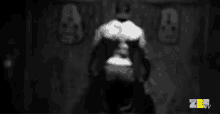 a man flexes his muscles in front of a wall that has the number 9