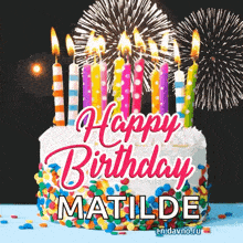 a birthday cake with candles and fireworks and the name matilde on it