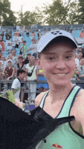 a woman in a green tank top with a red bull on it