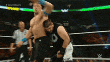 two men are wrestling in a wrestling ring with the words #canavodawns on the screen