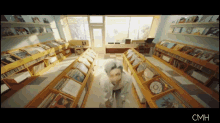 a blurred image of a library with the word cmh on the bottom right
