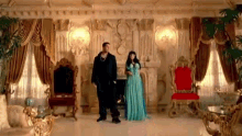 a man and a woman are standing in a living room .