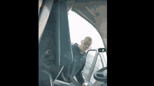 a man in an o'neill sweatshirt is sitting in the driver 's seat