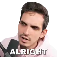 a man in a pink hoodie with the word alright on his face