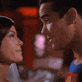 a man in a superman costume kisses a woman