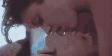 a man and a woman are kissing each other on the lips .