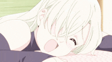 a girl with white hair and blue eyes laying down