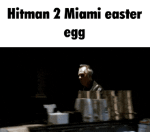 a man standing in front of a mirror with the words hitman 2 miami easter egg below him
