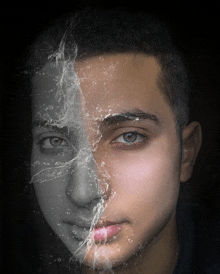 a black and white photo of a man 's face with half of his face covered in water