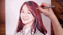 a person is drawing a picture of a woman with long hair