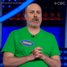 a man in a green shirt has a name tag that says jordan