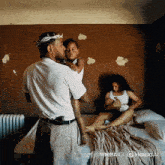 a man wearing a crown of thorns is holding a child while a woman feeds her baby
