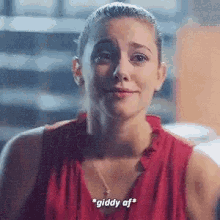 a woman in a red shirt is crying and talking .