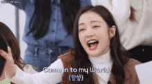 a woman says come in to my world in a video
