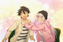 a girl in a pink jacket is holding a boy in a white shirt