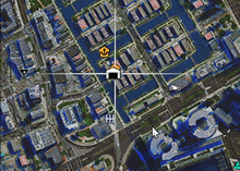 an aerial view of a city with a mouse pointer pointing to a house