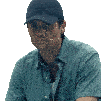 a man wearing a hat and a blue shirt is looking at the camera