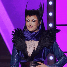 a woman with a tattoo of a butterfly on her chest is wearing a blue and black outfit