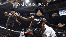 a basketball player wearing a heat jersey is jumping in the air during a game