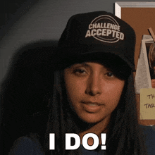 a woman wearing a hat that says challenge accepted