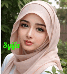 a close up of a woman wearing a hijab with syifa written on the bottom