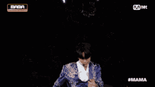 a group of people are standing in front of a mnet banner