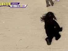 a woman with curly hair is laying on her back on the floor