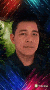 a man 's face is displayed in front of a colorful background with the words " vidstatus " at the bottom