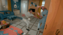 a man and a woman are dancing in a room