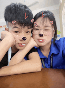 a boy and a girl are posing for a picture and the girl is wearing a lanyard that says " discovery world "