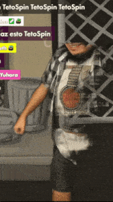 a man in a plaid shirt is standing in front of a trash can and a sign that says tetospin