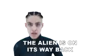 the alien is on its way back is written above a woman 's face