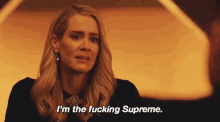 a woman says " i 'm the fucking supreme " in a dark room