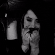 a woman with blood on her face is holding a knife