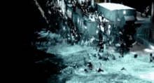 a group of people are swimming in a pool with a large building in the background .