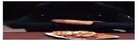a person is taking a piece of pizza from a plate of food .