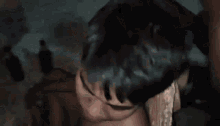 a man without a shirt is taking a selfie with a camera .