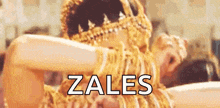 a woman in a gold costume with the word zales in white letters