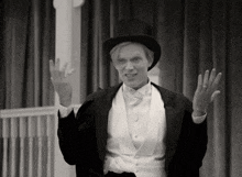 a black and white photo of a man in a top hat