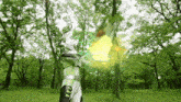 a man in a green and white costume is holding a sword in a park